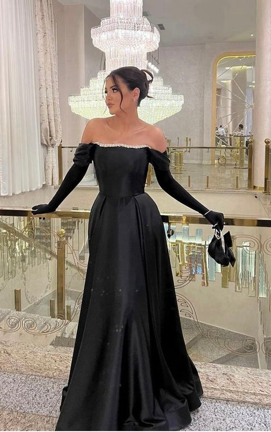 Robe de soirée longue élégante en satin noir, coupe trapèze, épaules dénudées, ornée de perles et de gants. Idéale pour l'hiver, les bals de promo et les soirées. AB2004