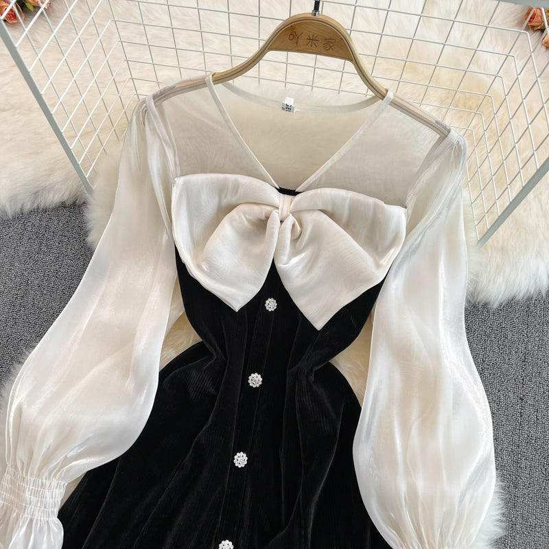 Robe noire à manches longues et col en V avec nœud et jolie robe tendance RF0211